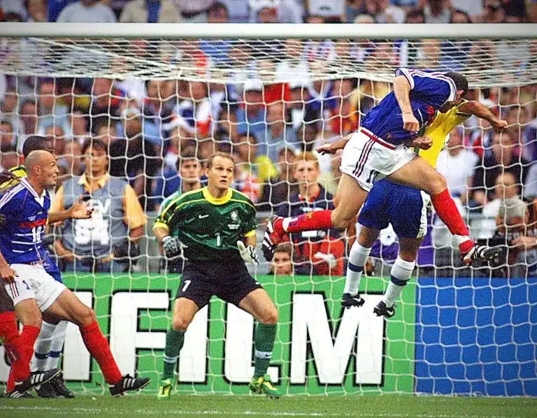 Diante do goleiro Taffarel, Zidane disputa com zagueiro e cabeceia para fazer um dos gols da Frana na final da Copa de 1998