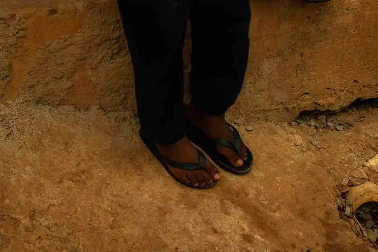 Pés de uma criança na ocupação vila serrinha em mariana